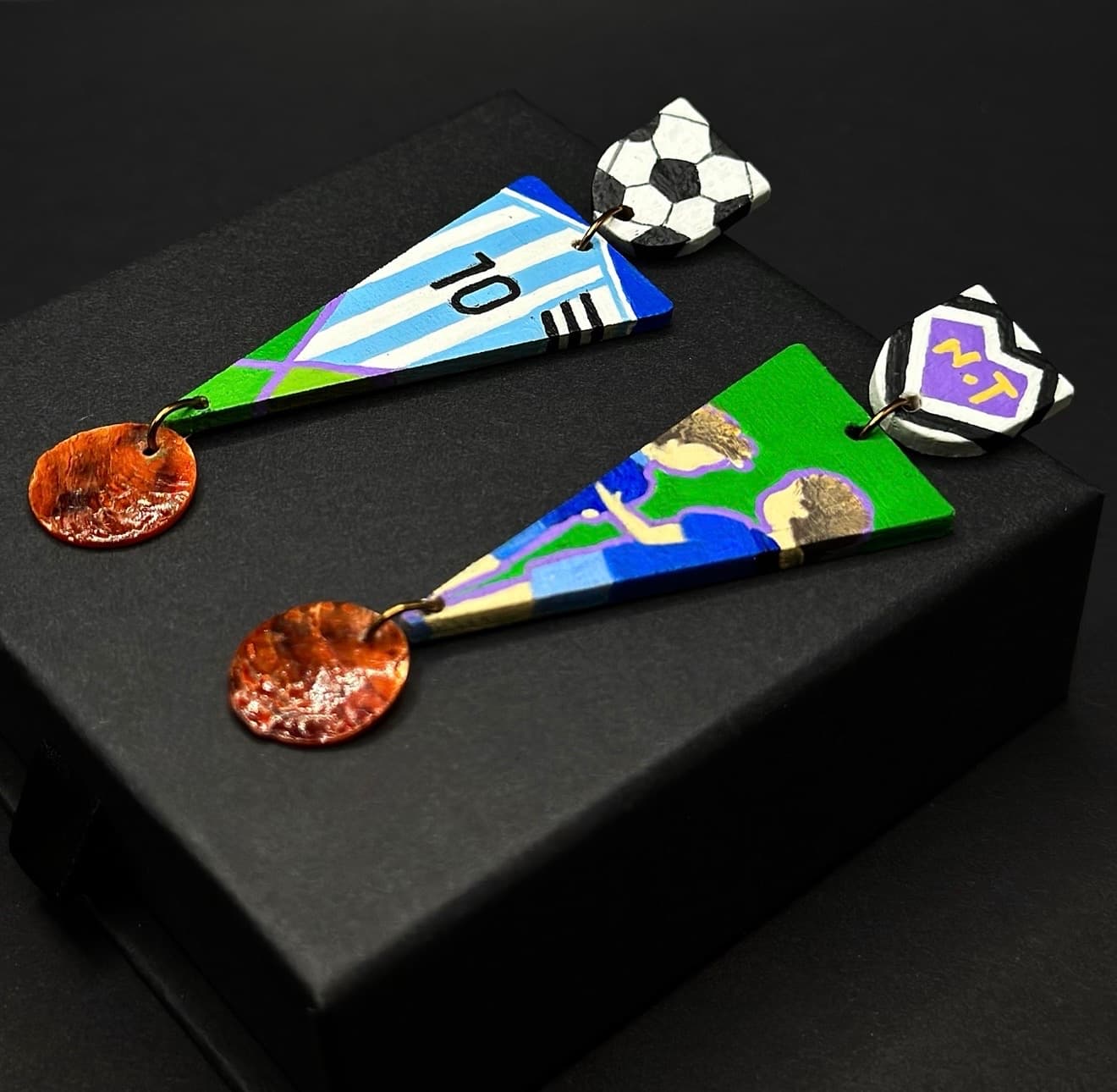 Custom soccer-themed earrings — angled view
