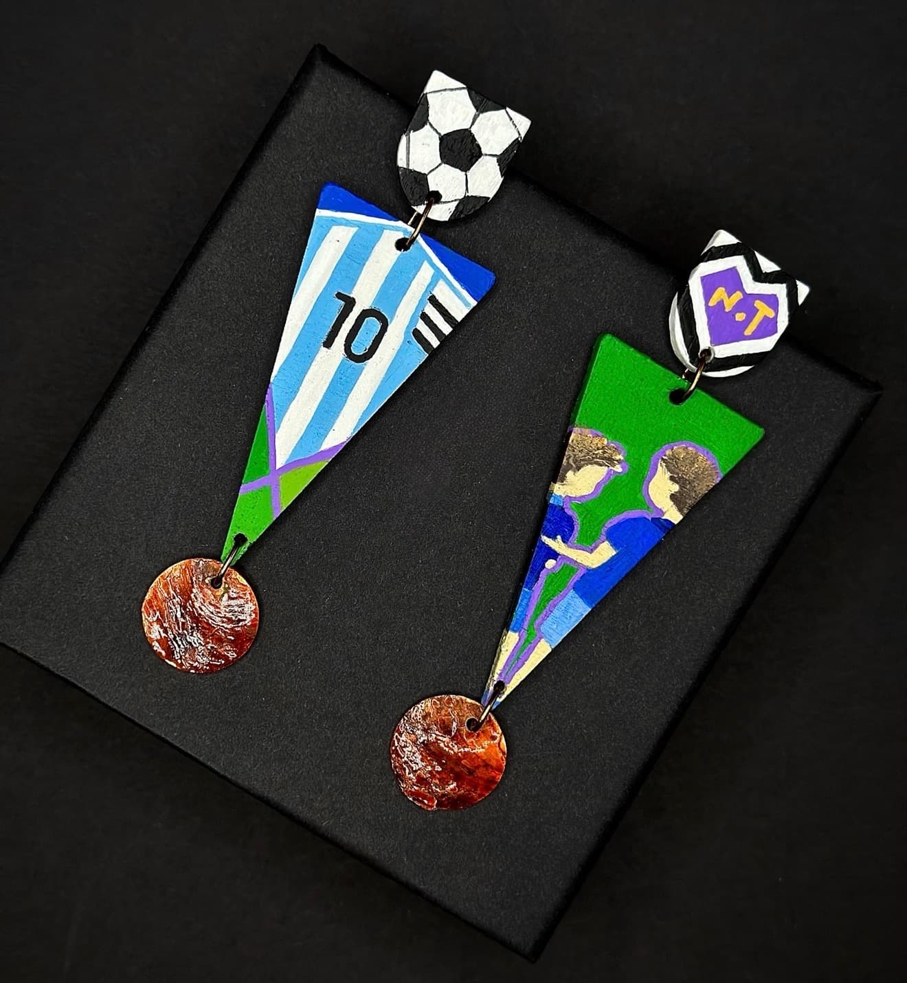 Custom soccer-themed earrings — flat lay